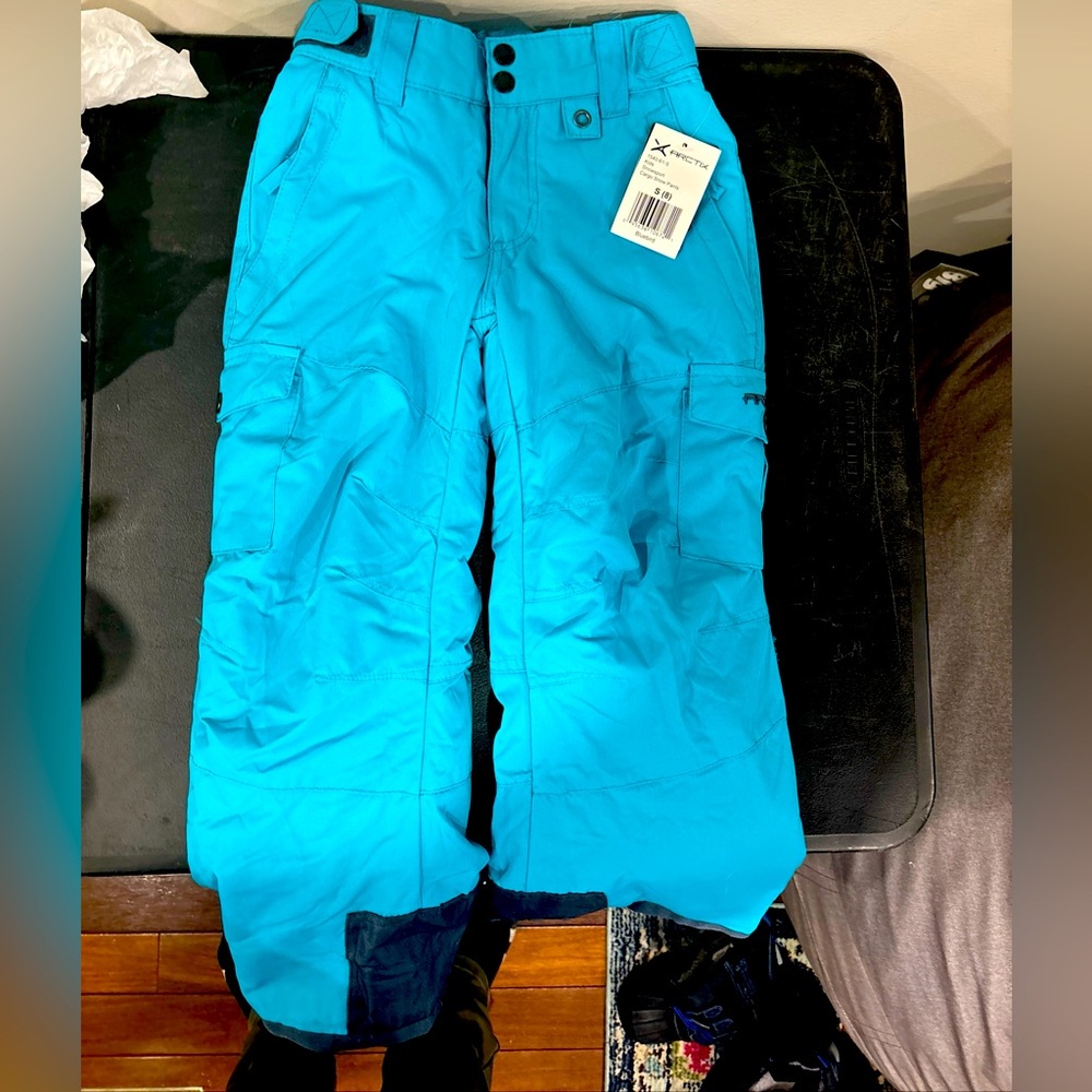 Snow pants. Button. Zippers at ankles. Waterproof.  Size 8. Never worn has tags